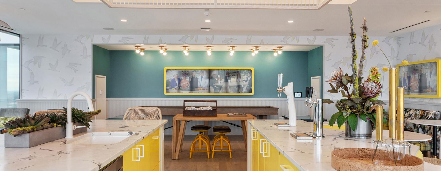 a kitchen with a large green wall